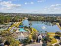 Aerial view of the neighborhood amenities featuring a pool, clubhouse, and beautiful lake at 19504 Lily Pond Ct, Brooksville, FL 34601