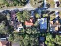 Aerial shot showcasing the house layout, neighborhood, and surrounding greenery at 5518 Pinehurst Dr, Spring Hill, FL 34606
