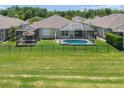 Spacious backyard with a pool, and a beautiful screened-in lanai at 9819 Bridgeton Dr, Tampa, FL 33626