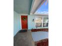 Inviting front entryway with a bright red door and decorative wreath at 1817 Dartmouth Dr, Holiday, FL 34691