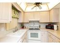 Charming kitchen with white cabinets, modern appliances, and decorative accents create a welcoming culinary space at 4533 Marine Pkwy # 206, New Port Richey, FL 34652