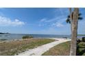 Scenic waterfront property featuring a charming walkway with bay views and lush landscaping at 5000 Culbreath Key Way # 9-221, Tampa, FL 33611