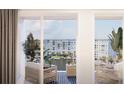 Private balcony with stylish seating, views of the water, and lush greenery at 5015 Us Highway 19 # 501, New Port Richey, FL 34652