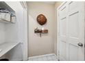 Neutral entryway with coat rack, decorative items, and a white door at 705 Riverside Dr, Tarpon Springs, FL 34689