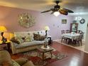 Inviting living room with a comfortable couch, decorative rug, and a view to the dining area at 8150 Braddock Cir # 4, Port Richey, FL 34668