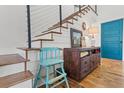 Staircase with modern cable railing, wood treads, and stylish decor accents at 11151 Lu Wista Ln, Brooksville, FL 34601