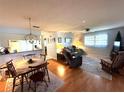 Open concept living area with adjacent dining space at 11737 Spring Tree Ln, Port Richey, FL 34668