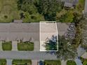 Aerial view of the property showing the roof, yard, driveway, and surrounding neighborhood at 18325 Whitacre Cir, Hudson, FL 34667