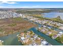 Wide aerial view of a coastal community with homes along canals and waterways, showcasing the area's landscape at 3403 Holly Springs Dr, Hernando Beach, FL 34607