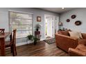 Inviting living room featuring wood floors, neutral walls, and a glimpse of the front yard through window blinds at 5830 34Th N Ave, St Petersburg, FL 33710