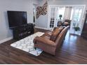 Spacious living room featuring a plush rug, TV, and sliding doors to another area of the home at 5830 34Th N Ave, St Petersburg, FL 33710