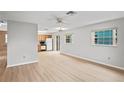 Large living room with an open layout, ceiling fan, and modern flooring at 6028 Wilds Dr # 6A, New Port Richey, FL 34653