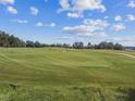 Green golf course with sand traps on a sunny day at 6452 Summit View Dr, Brooksville, FL 34601