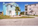 Charming two-story coastal home featuring a well-manicured lawn with attractive landscaping at 6613 Josie Ln, Hudson, FL 34667