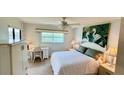 Comfortable bedroom with water views, desk, and ceiling fan at 8150 Brent St # 713, Port Richey, FL 34668