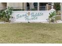 Entrance sign for Sand Pebble Pointe at street level with healthy lawn at 8150 Brent St # 713, Port Richey, FL 34668