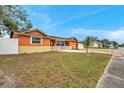 Cozy single-story home with a well-maintained lawn and inviting curb appeal in a quiet neighborhood at 9220 Saint Regis Ln, Port Richey, FL 34668