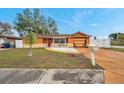 Charming single-story home with a unique orange and yellow garage door at 9220 Saint Regis Ln, Port Richey, FL 34668