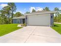 Exterior shot showcasing the home's garage, driveway, and clean architectural lines at 11345 Thrasher Ave, Weeki Wachee, FL 34614