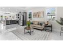Bright living room with modern sofa, elegant rug, and an open concept layout at 12706 N Ola Ave, Tampa, FL 33612