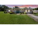 Charming single-story home with a well-manicured front lawn and inviting double door entry at 12757 Circle Lake Dr, Hudson, FL 34669