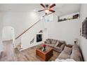 Bright living room with wood floors, ceiling fan, high ceilings, and stairway to the second floor at 1801 Loch Haven Ct, Trinity, FL 34655