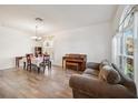 Open living area featuring wood floors, neutral walls, large windows and a charming piano at 1801 Loch Haven Ct, Trinity, FL 34655