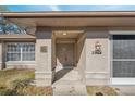 Inviting front entrance with decorative accents, featuring a sheltered porch area and address display at 2454 Landover Blvd, Spring Hill, FL 34608