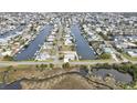 Expansive aerial view of a waterfront community featuring canals and well-maintained homes in a desirable neighborhood at 3449 Companero Entra, Hernando Beach, FL 34607