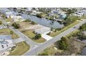 Inviting single-story home with a waterfront view, large driveway, and serene landscaping at 3449 Companero Entra, Hernando Beach, FL 34607