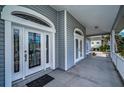 Inviting front porch with a detailed glass front door and covered entrance at 5050 Limestone Dr, Port Richey, FL 34668