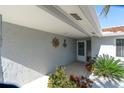 Inviting home entrance featuring decorative nautical accents and lush landscaping, creating a warm and welcoming ambiance at 5061 Ensign Loop, New Port Richey, FL 34652
