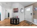 Bright foyer features wood-look flooring and a front door with a pet door at 610 Cobia Way, Oldsmar, FL 34677