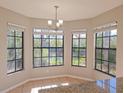 Bright breakfast nook with granite counters and a beautiful view of nature at 7104 Hummingbird Ln, New Port Richey, FL 34655