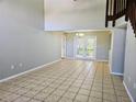 Open-concept living room with tile floors and large french doors at 7104 Hummingbird Ln, New Port Richey, FL 34655