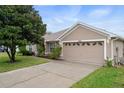 Charming single-story home features a well-maintained lawn, a spacious two-car garage, and appealing neutral-toned exterior paint at 7292 Sherman Hills Blvd, Brooksville, FL 34602