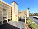 Condo complex with lovely landscaping, covered parking, and a welcoming entrance at 9000 Commodore Dr # 302, Seminole, FL 33776
