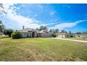 Charming exterior of the house with a well-manicured lawn and a three-car garage at 10188 Whisper Ridge Trail Trl, Weeki Wachee, FL 34613