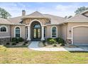Close up of the front entrance, showcasing a stone archway and double doors at 10188 Whisper Ridge Trail Trl, Weeki Wachee, FL 34613