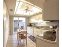 Bright kitchen featuring white cabinetry, granite countertops, and a dining area with a sliding door to the patio at 12400 Eagleswood Dr # A, Hudson, FL 34667