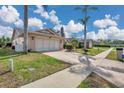 Inviting home featuring a well-manicured lawn and a spacious driveway at 13032 Pinnacle Ln, Hudson, FL 34669