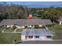 Aerial view of the home with convenient carport parking and manicured landscaping, set in a tranquil neighborhood at 4917 Grist Mill Cir, New Port Richey, FL 34655