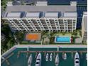 An aerial view of a building showcasing the pool, tennis court and marina at 5015 Us Highway 19 # 503, New Port Richey, FL 34652