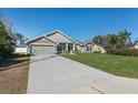 Well-maintained single Gathering home features an extended driveway and lush green lawn at 5139 Jenson Ave, Spring Hill, FL 34608