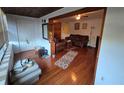 View of living room showcasing gleaming hardwood floors and an open floor plan at 5800 Massachusetts Ave, New Port Richey, FL 34652