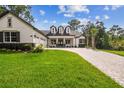 Charming home featuring a brick driveway, three-car garage, and a manicured lawn at 6470 Summit View Dr, Brooksville, FL 34601