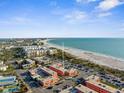Stunning aerial view capturing the property's prime location near the beach with city views and turquoise waters at 6800 Sunset Way # 1006, St Pete Beach, FL 33706