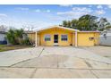 Inviting one-story home featuring a covered front entry and a large driveway for parking at 7427 Congress St, New Port Richey, FL 34653
