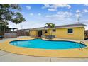 Backyard oasis with a sparkling in-ground pool and a private fenced yard at 7427 Congress St, New Port Richey, FL 34653