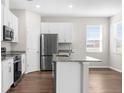 Bright kitchen featuring stainless steel appliances and a central island at 8338 Maybelle Dr, Weeki Wachee, FL 34613